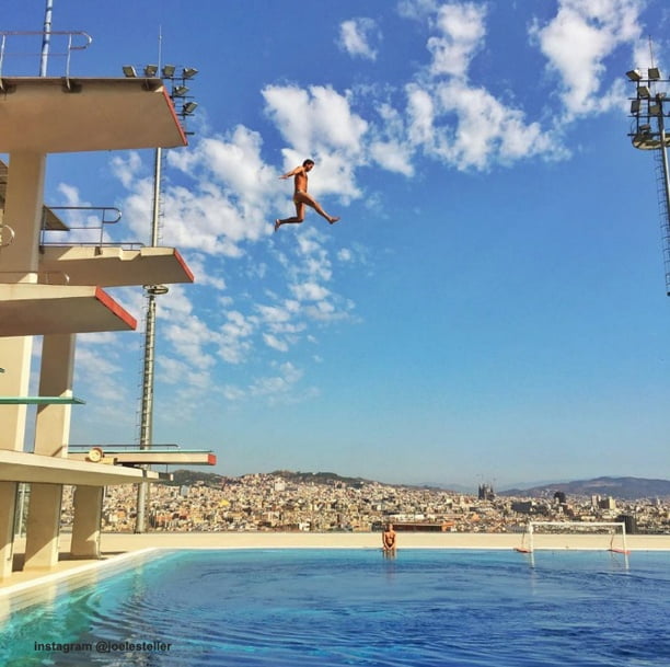 man die springt in het zwembad vanaf de duiktoren, olympische zwembad in Barcelona